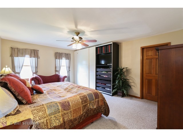 978 Plum Tree Road Fox River Grove, IL 60021 - Photo 15 of 25 a bedroom with a bed a chandelier and a television