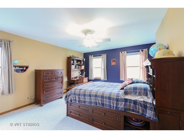 978 Plum Tree Road Fox River Grove, IL 60021 - Photo 19 of 25 a bedroom with a bed and a dresser with wooden floor