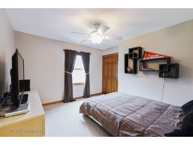 978 Plum Tree Road Fox River Grove, IL 60021 - Photo 20 of 25 a bedroom with a bed and a flat screen tv