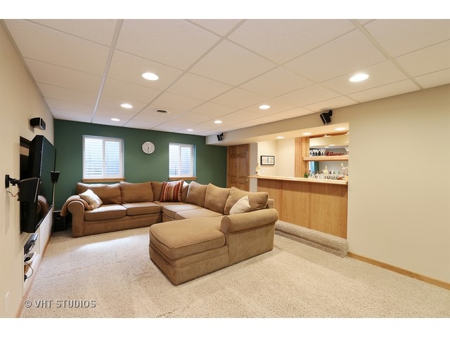 978 Plum Tree Road Fox River Grove, IL 60021 - Photo 23 of 25 a living room with furniture and a flat screen tv