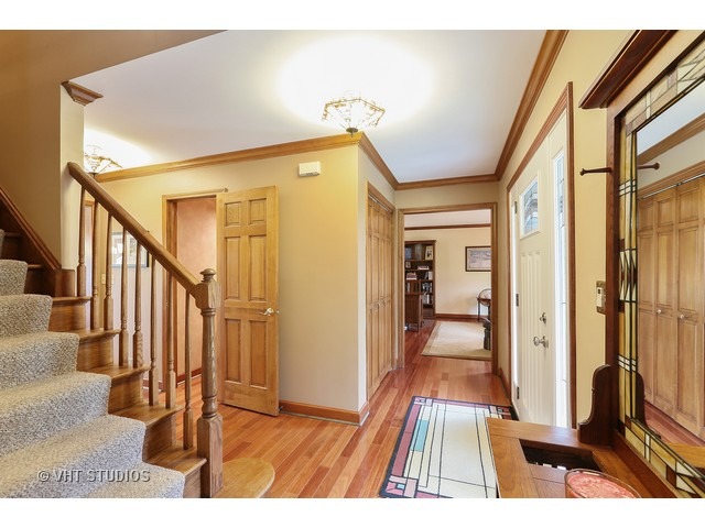 978 Plum Tree Road Fox River Grove, IL 60021 - Photo 4 of 25 a view of a hallway with wooden floor and staircase