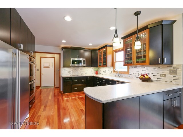 978 Plum Tree Road Fox River Grove, IL 60021 - Photo 7 of 25 a kitchen with stainless steel appliances granite countertop a sink a stove and a refrigerator