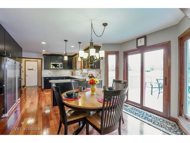 978 Plum Tree Road Fox River Grove, IL 60021 - Photo 9 of 25 a view of a dining room with furniture window and wooden floor