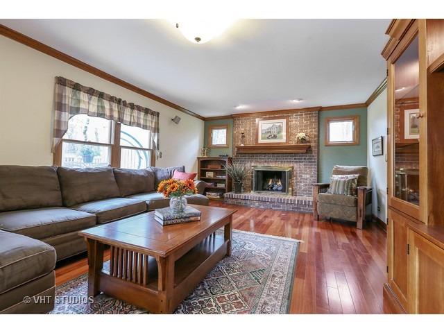 978 Plum Tree Road Fox River Grove, IL 60021 - Photo 10 of 25 a living room with furniture a window and a fireplace