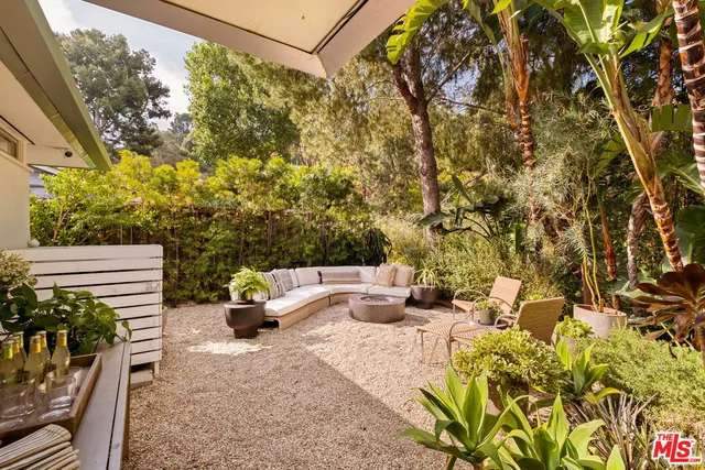a view of a patio with table and chairs and potted plants