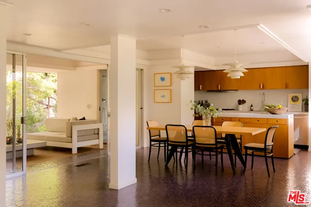 a dining room with furniture a chandelier and window