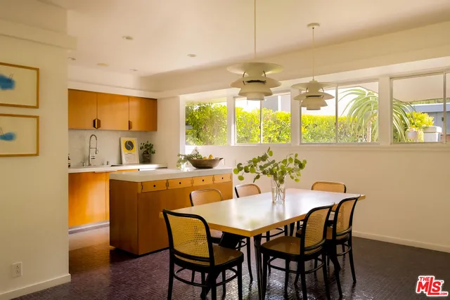 a living room with fireplace furniture and a large window