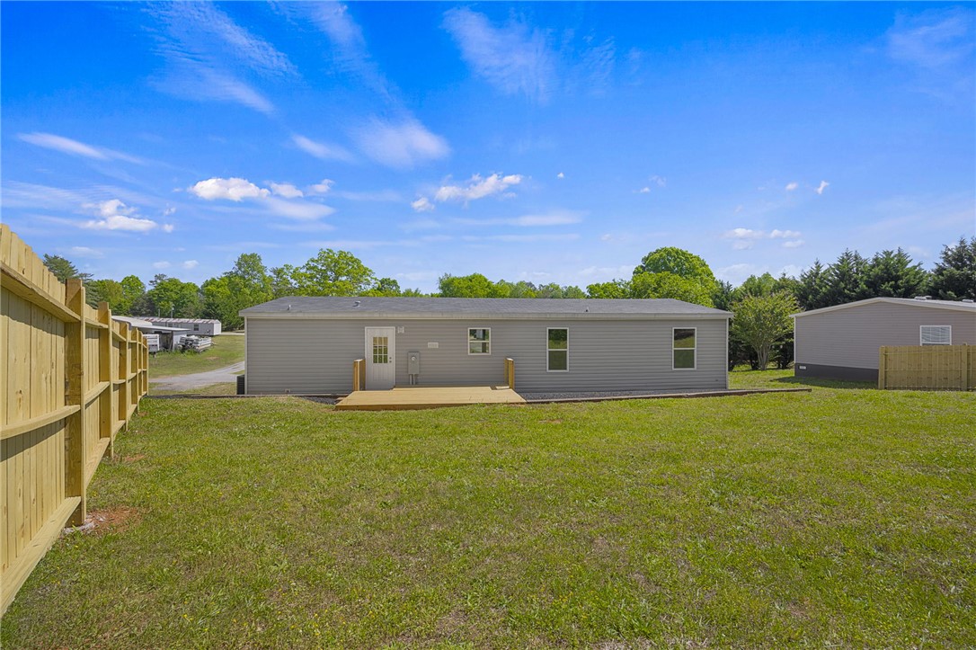375 Griggs Road Six Mile, SC 29682 - Photo 27 of 36 This spacious backyard features a wooden fence and a charming porch, perfect for outdoor enjoyment.