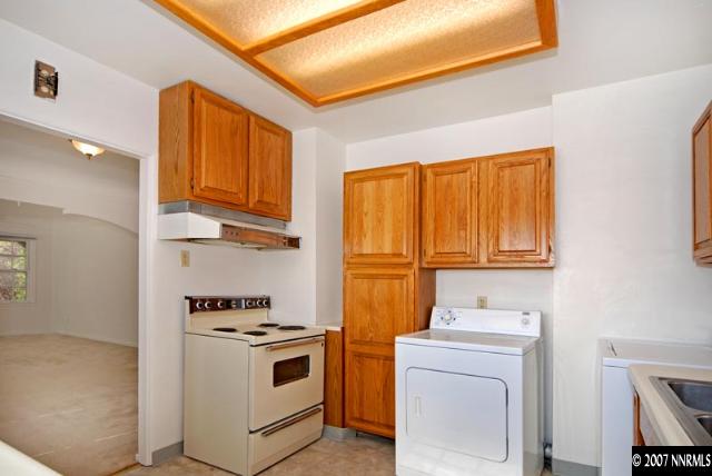 517 Thoma Street Reno, NV 89502 - Photo 5 of 9 a kitchen with a stove top oven a sink and a microwave