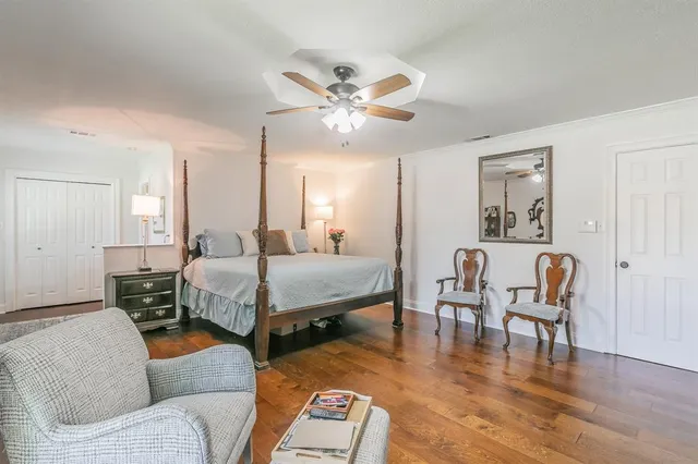 a spacious bedroom with a bed and a chandelier