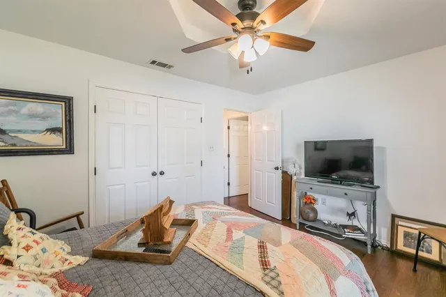 a bedroom with furniture and a flat screen tv