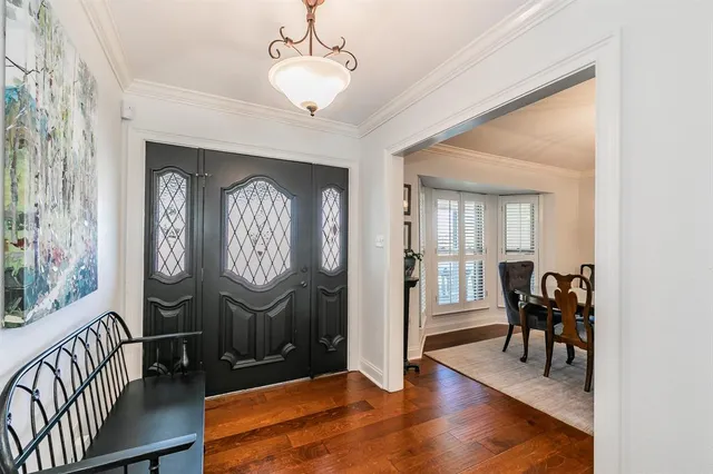 a view of a dining room with furniture wooden floor and chandelier