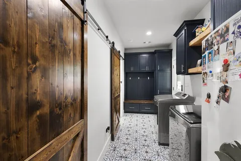 a kitchen with stainless steel appliances granite countertop a stove a refrigerator and a cabinets