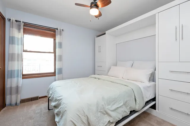 a bedroom with a bed and a window