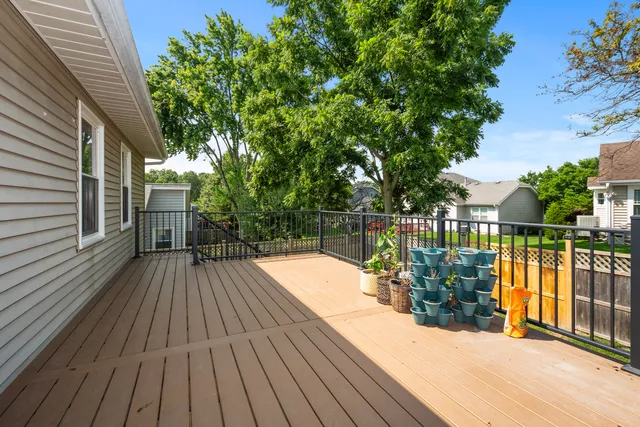 a view of a balcony with wooden floor and fence