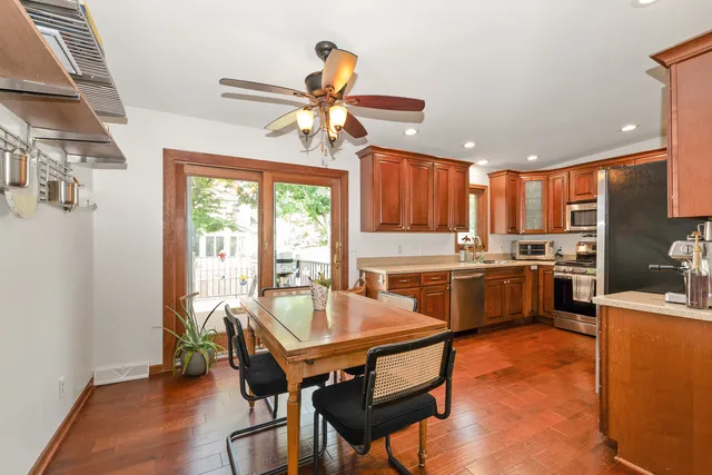 a kitchen with a table chairs refrigerator and microwave