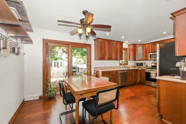 a kitchen with a table chairs stove and refrigerator