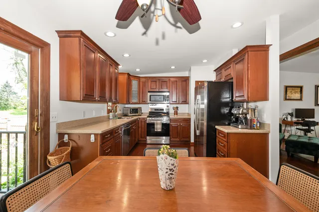 a kitchen with refrigerator a stove and furniture