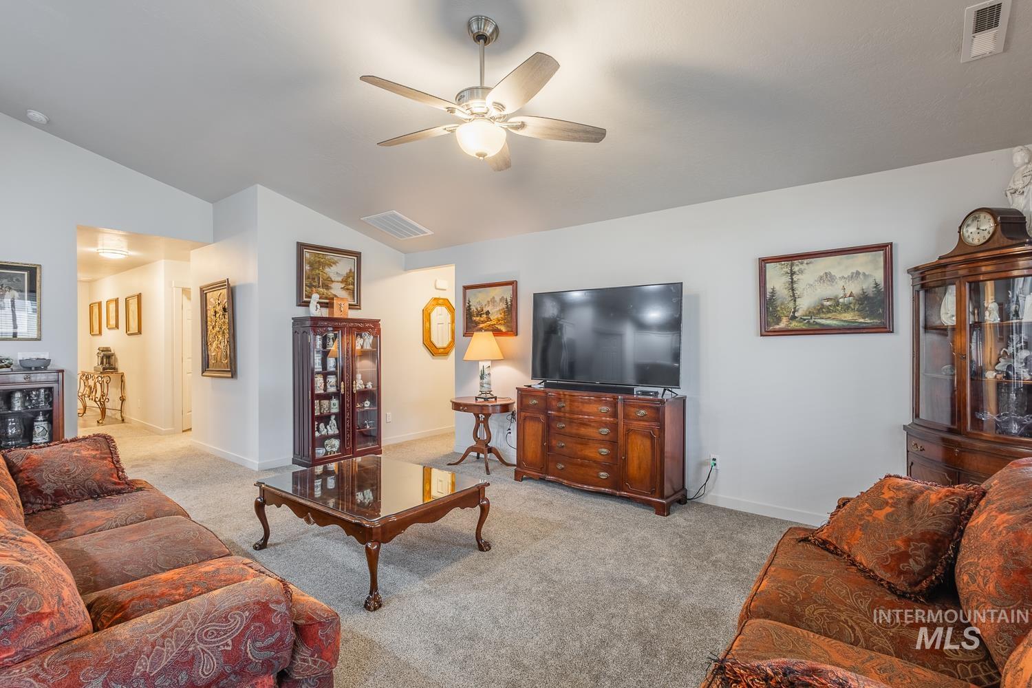 11309 West Viola Street Nampa, ID 83651 - Photo 12 of 37 Carpeted living room with ceiling fan and lofted ceiling