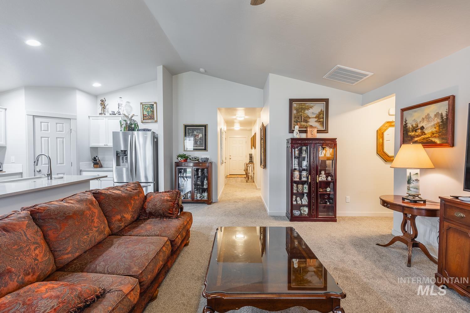 11309 West Viola Street Nampa, ID 83651 - Photo 13 of 37 Living room featuring light colored carpet, lofted ceiling, and recessed lighting