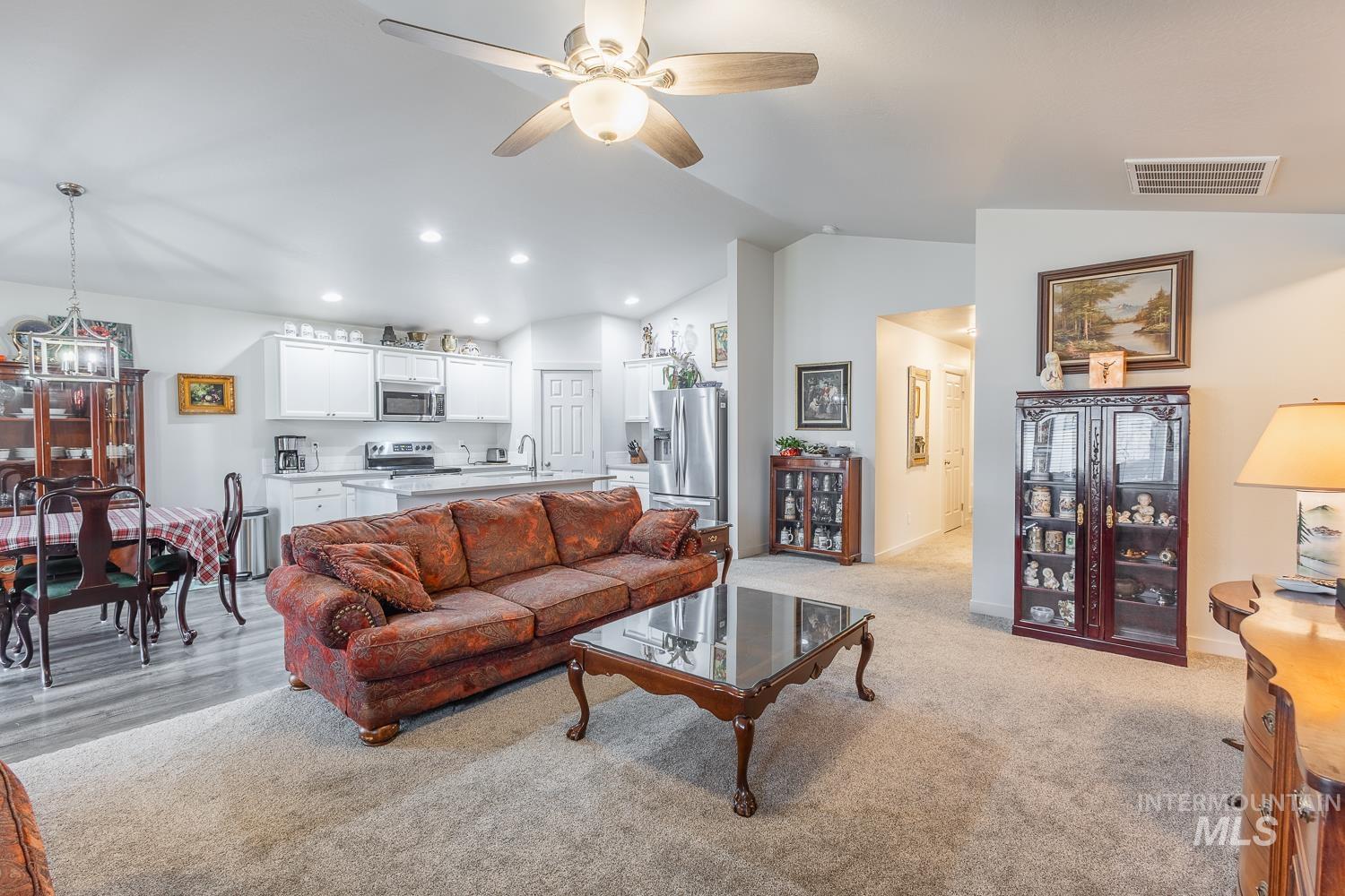 11309 West Viola Street Nampa, ID 83651 - Photo 14 of 37 Living area with a ceiling fan, recessed lighting, light colored carpet, a chandelier, and high vaulted ceiling
