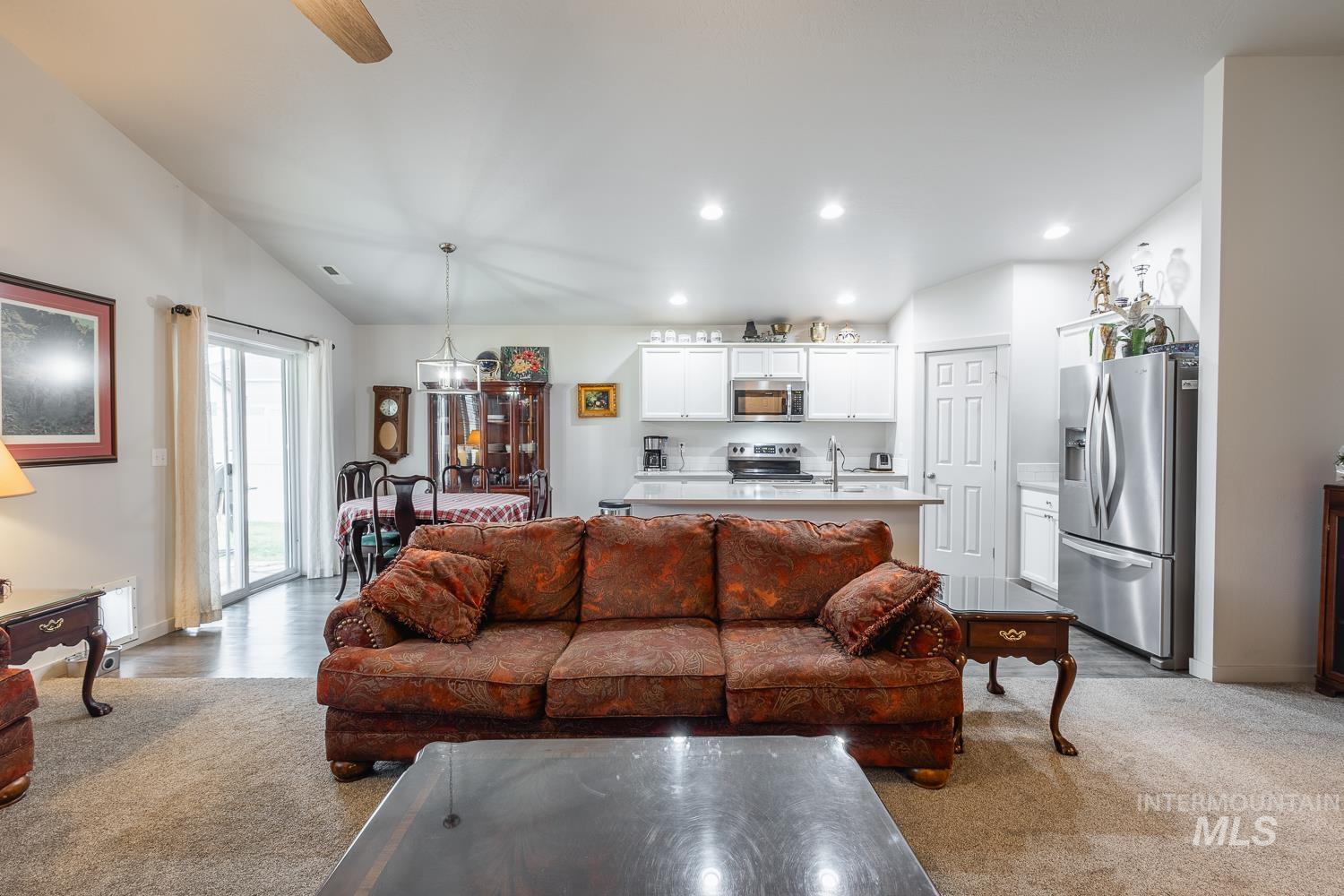 11309 West Viola Street Nampa, ID 83651 - Photo 15 of 37 Living room with lofted ceiling, recessed lighting, light carpet, and ceiling fan