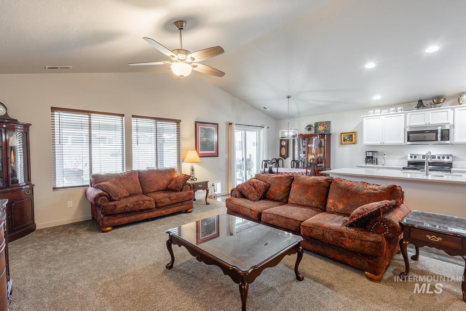 11309 West Viola Street Nampa, ID 83651 - Photo 16 of 37 Living area with light carpet, lofted ceiling, a ceiling fan, and recessed lighting