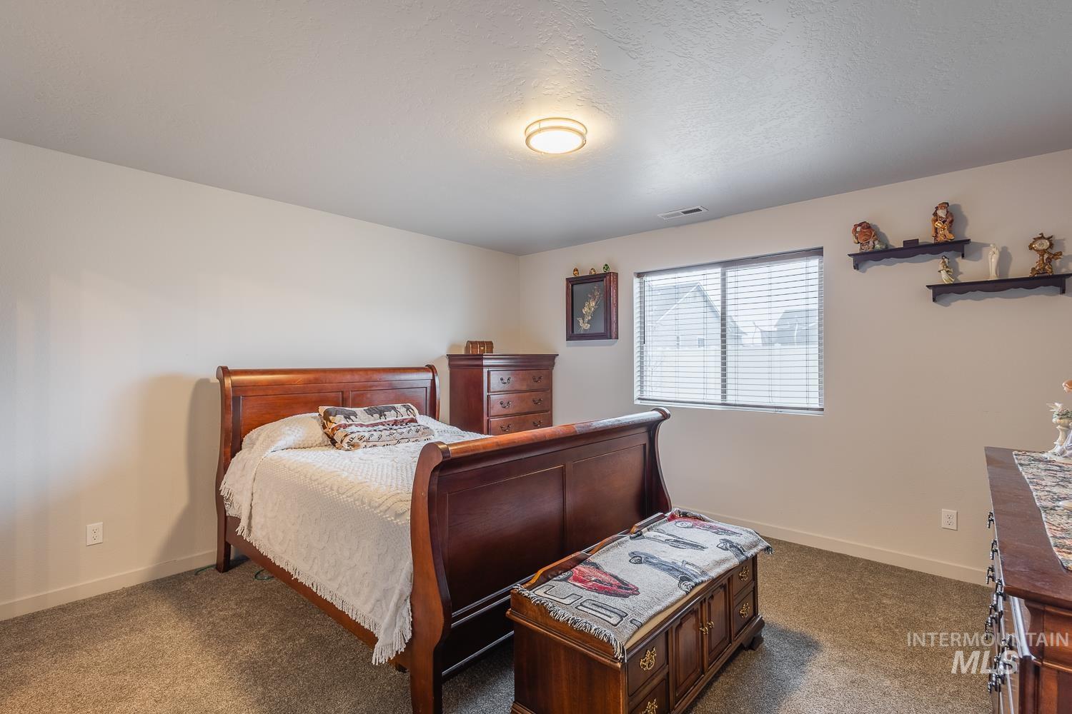 11309 West Viola Street Nampa, ID 83651 - Photo 21 of 37 Bedroom with carpet flooring and a textured ceiling