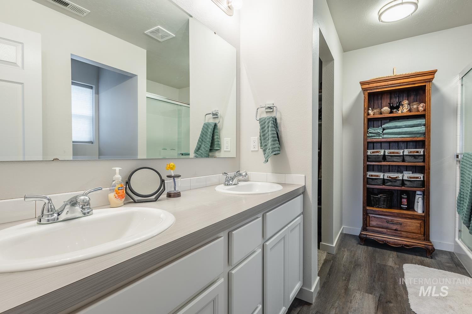 11309 West Viola Street Nampa, ID 83651 - Photo 23 of 37 Bathroom featuring double vanity, a stall shower, and dark wood-type flooring