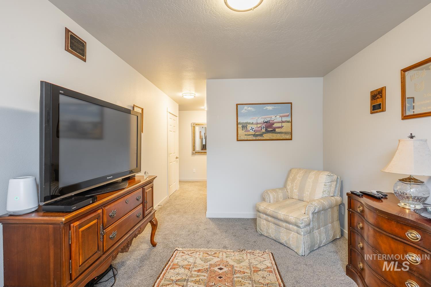 11309 West Viola Street Nampa, ID 83651 - Photo 27 of 37 Living area with light carpet and a textured ceiling