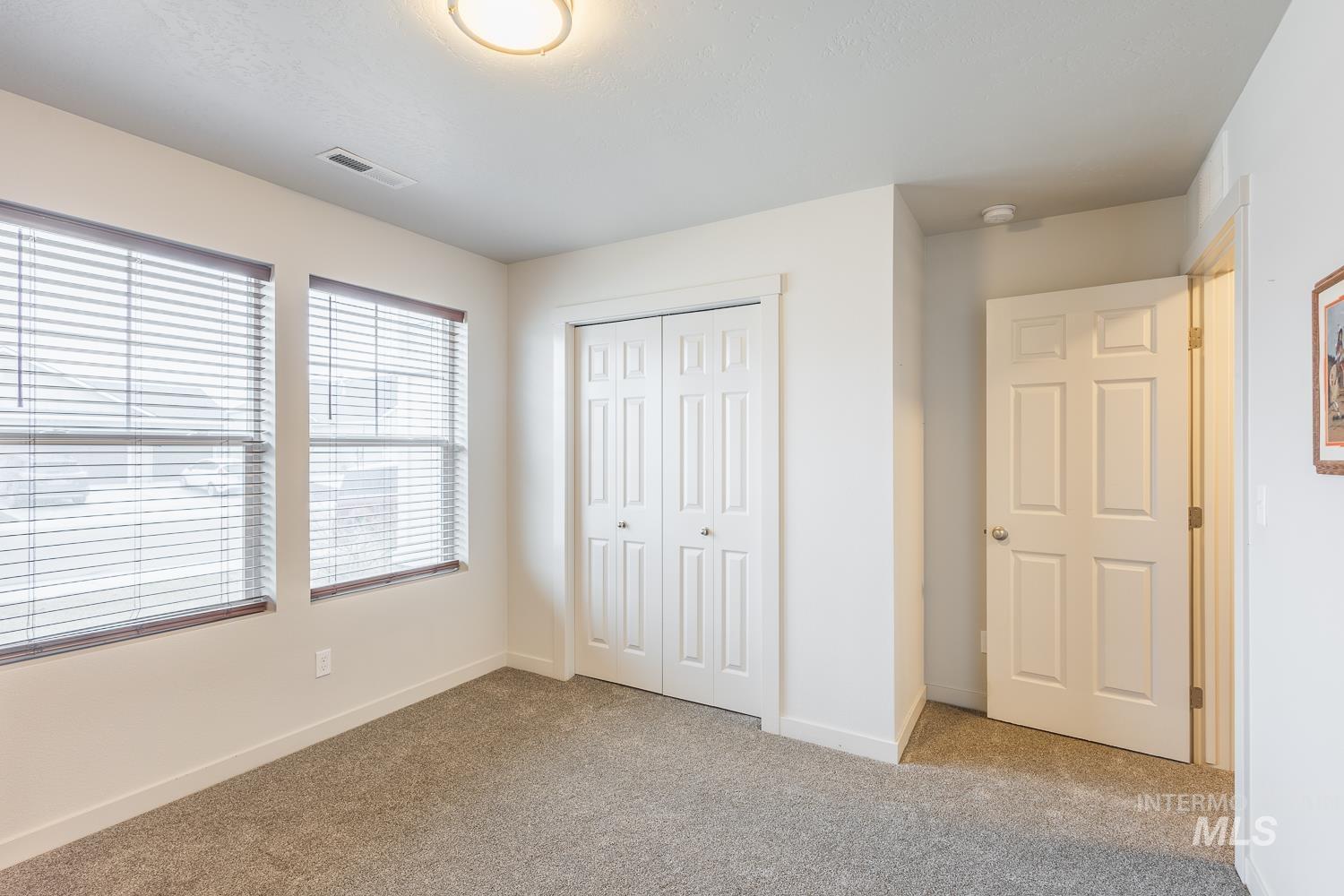 11309 West Viola Street Nampa, ID 83651 - Photo 29 of 37 Unfurnished bedroom featuring light colored carpet and a closet