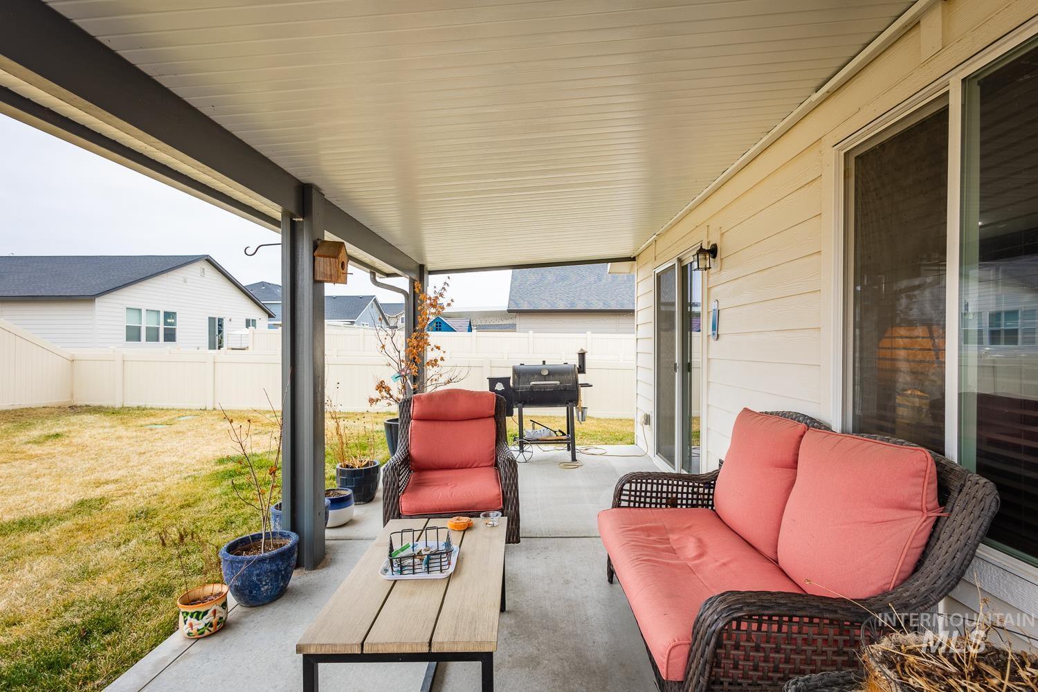 11309 West Viola Street Nampa, ID 83651 - Photo 34 of 37 Fenced backyard with an outdoor hangout area, a grill, and a patio