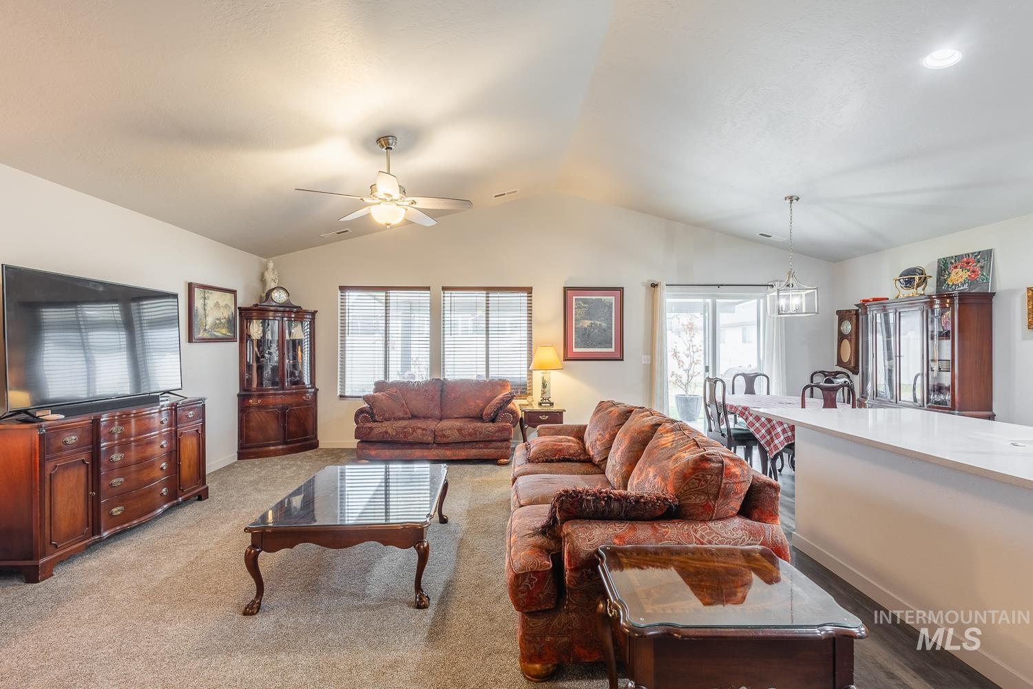 11309 West Viola Street Nampa, ID 83651 - Photo 10 of 37 Carpeted living room featuring lofted ceiling and a ceiling fan