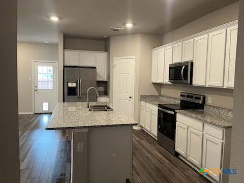 8419 Brahma Plns Road Temple, TX 76502 - Photo 3 of 17 a kitchen with kitchen island granite countertop a sink appliances and cabinets