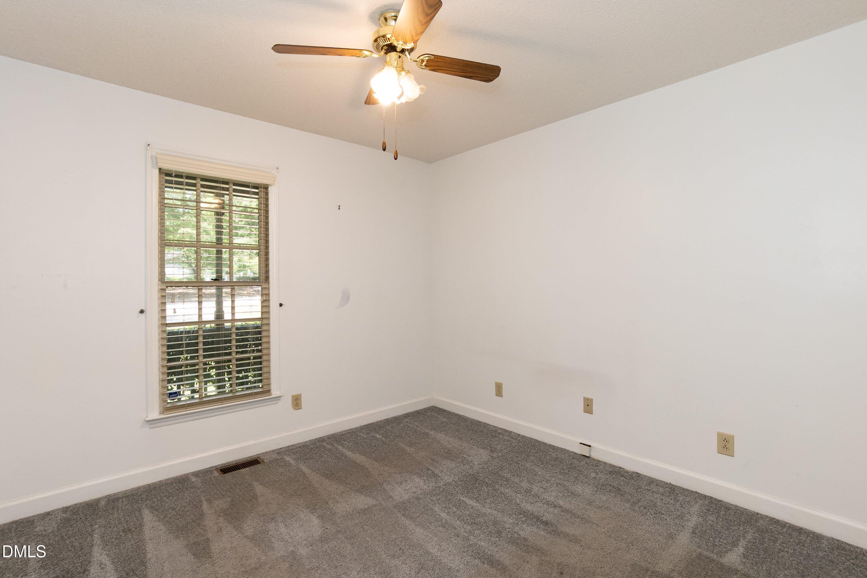 5604 Spring Pines Way Raleigh, NC 27616 - Photo 13 of 22 en empty room with windows and ceiling fan