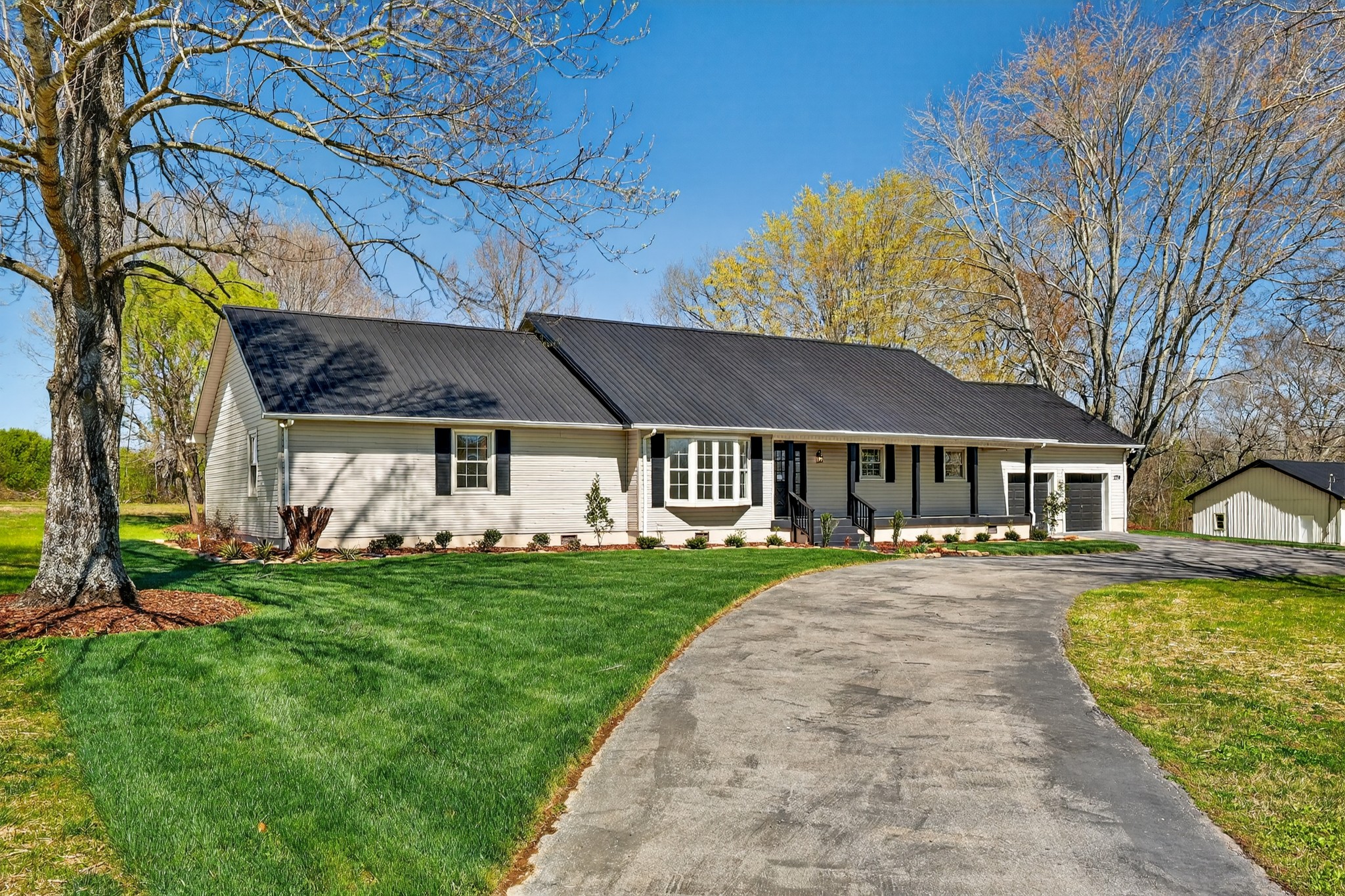 a front view of a house with a garden