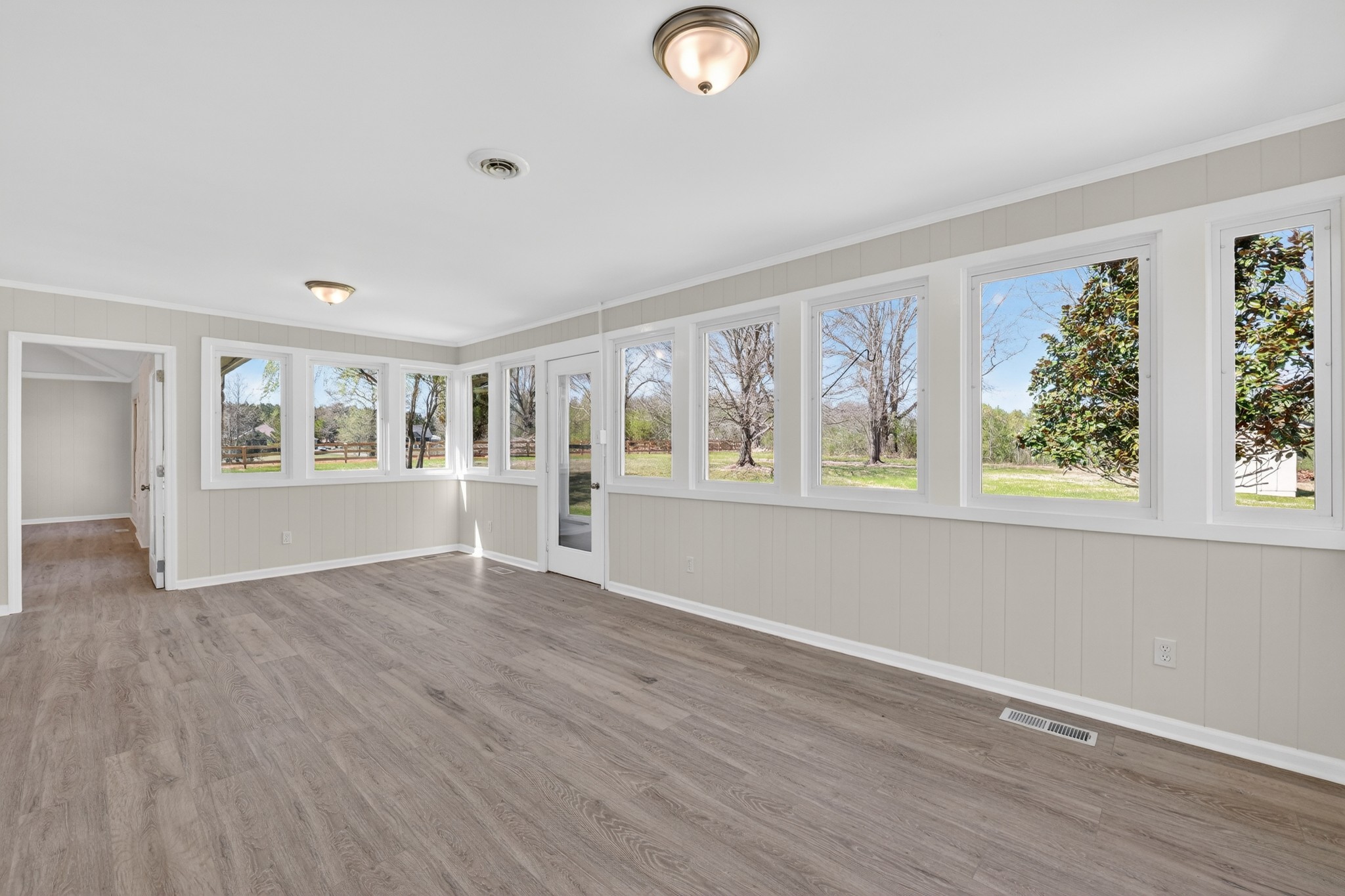 274 Howell Hill Road Kelso, TN 37348 - Photo 12 of 46 an empty room with wooden floor and windows