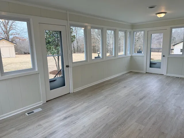 wooden floor in an empty room with a window