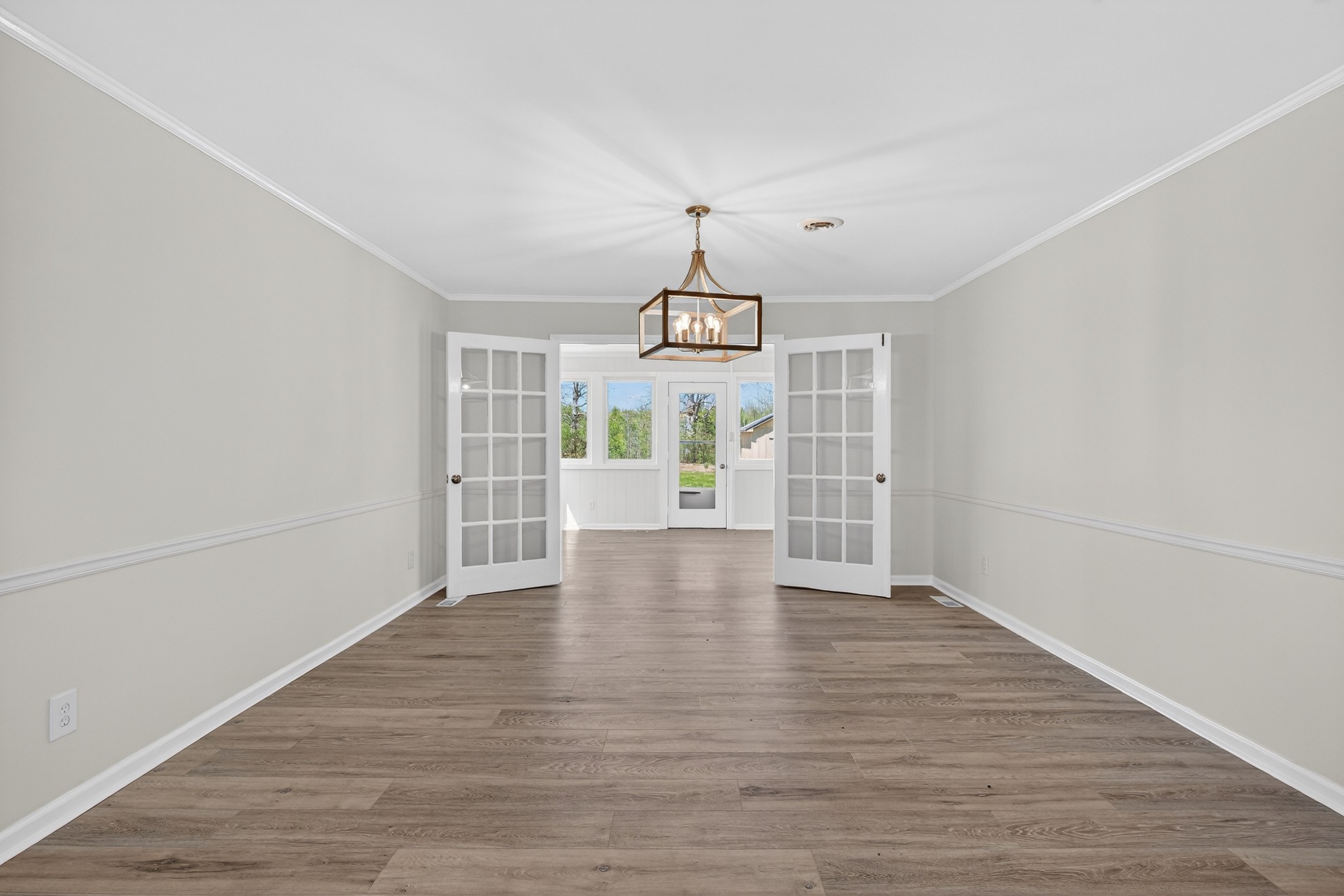 274 Howell Hill Road Kelso, TN 37348 - Photo 13 of 46 a view of an empty room with wooden floor and windows