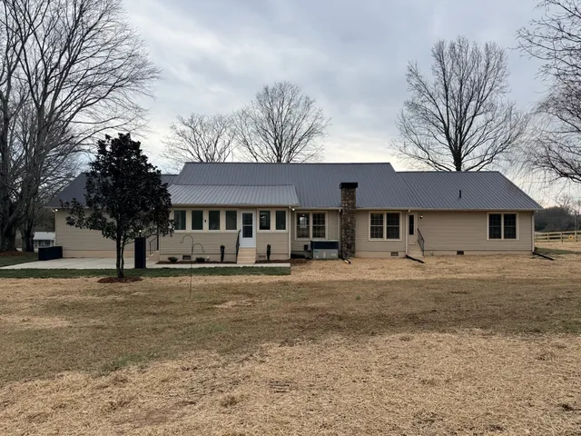 a front view of a house with a yard and a garage