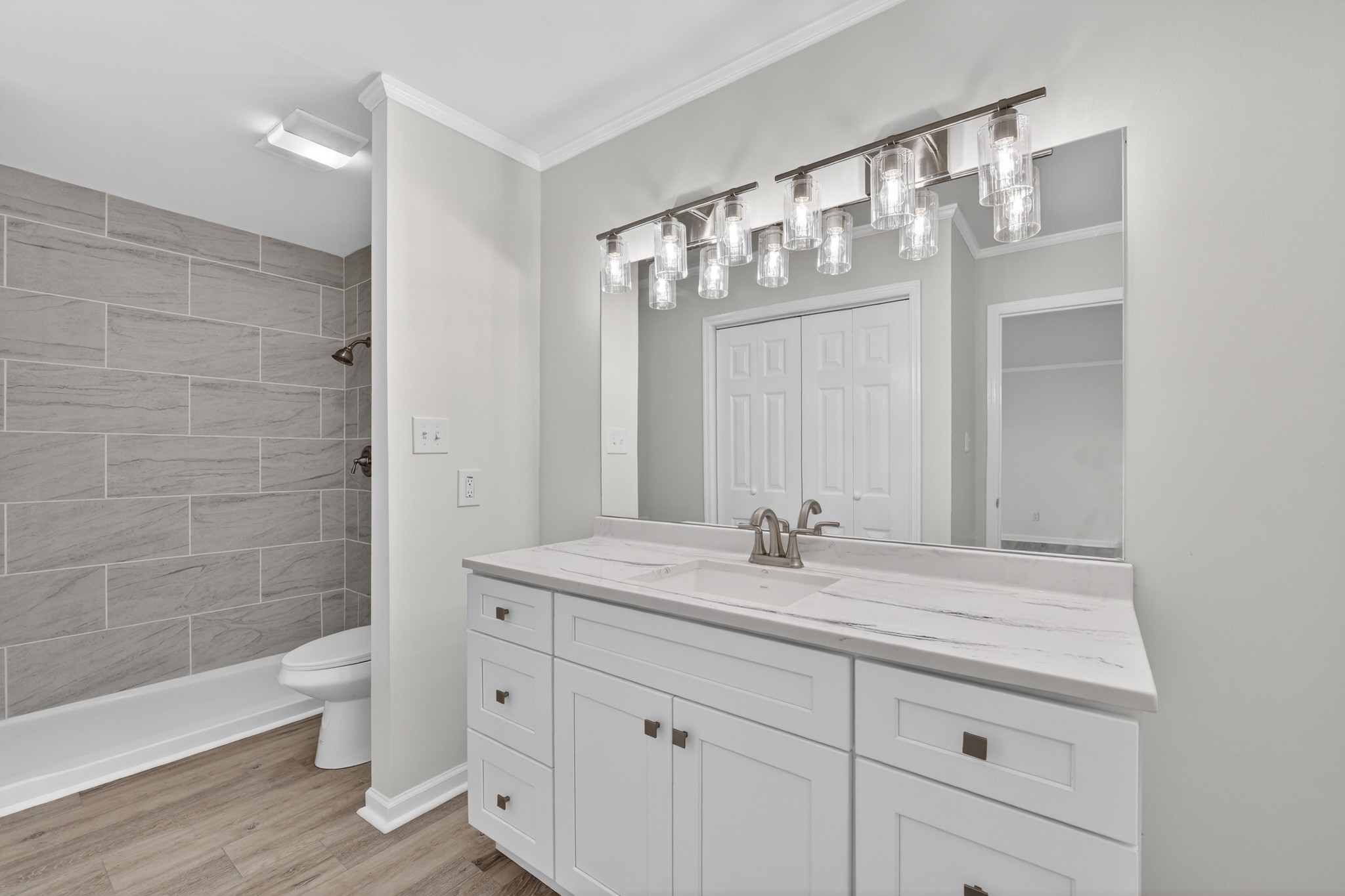 274 Howell Hill Road Kelso, TN 37348 - Photo 24 of 46 a bathroom with a granite countertop sink a toilet and a mirror