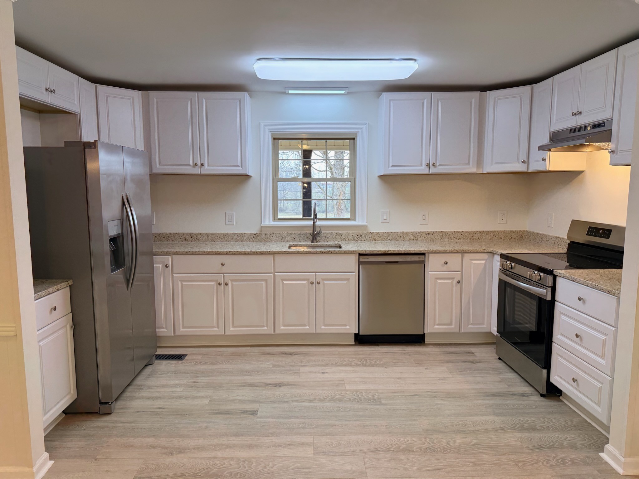 274 Howell Hill Road Kelso, TN 37348 - Photo 8 of 31 a kitchen with white cabinets stainless steel appliances and a sink