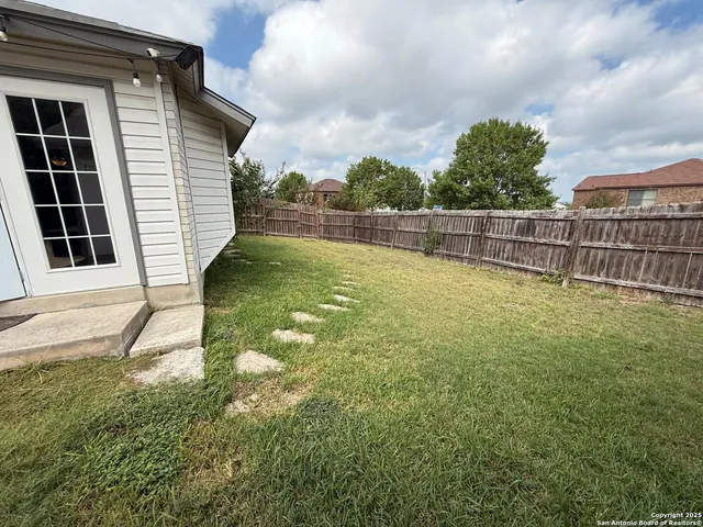 a view of a backyard with large trees
