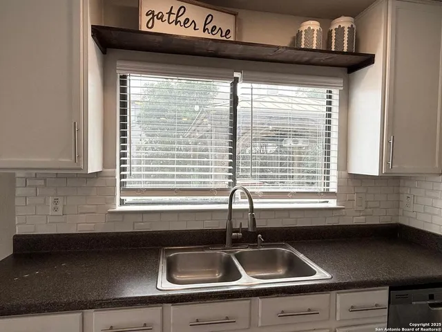 a kitchen with a sink a counter space and a window