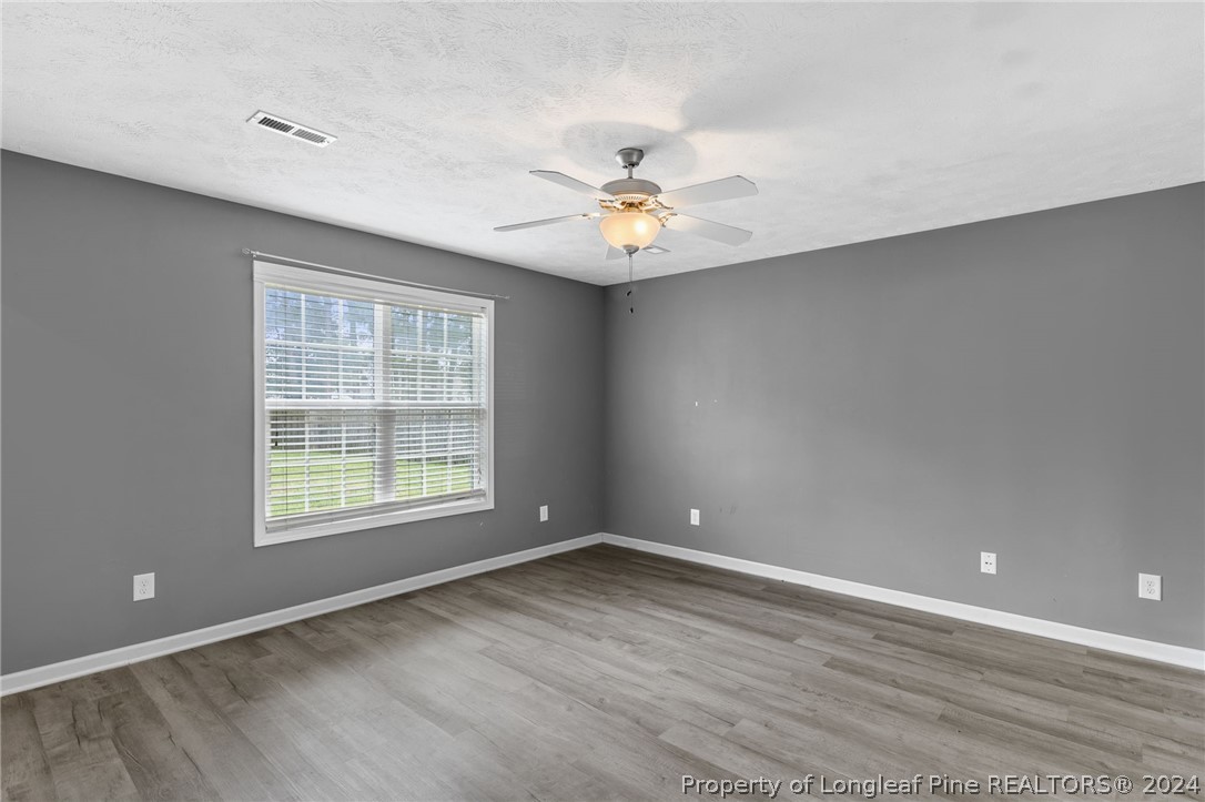 519 Cape Fear Road Raeford, NC 28376 - Photo 12 of 39 an empty room with a window and a ceiling fan