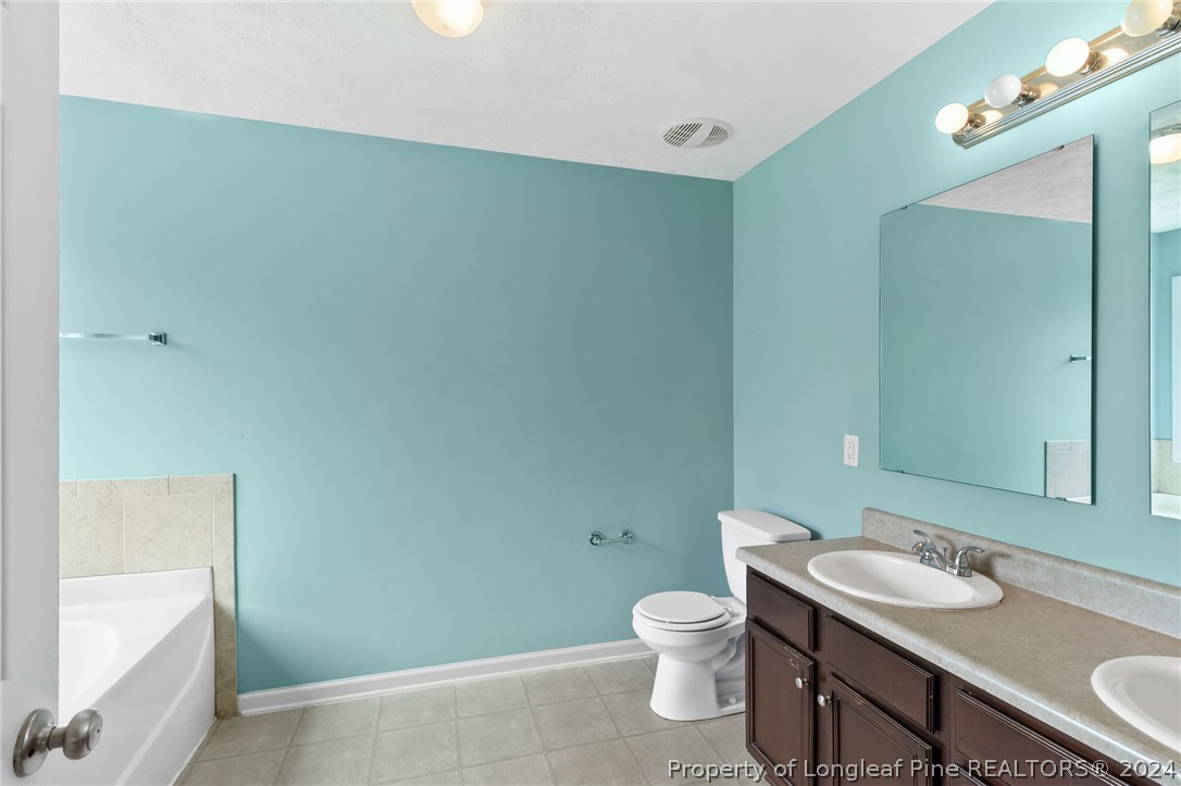 519 Cape Fear Road Raeford, NC 28376 - Photo 14 of 39 a bathroom with a granite countertop sink a toilet and a mirror