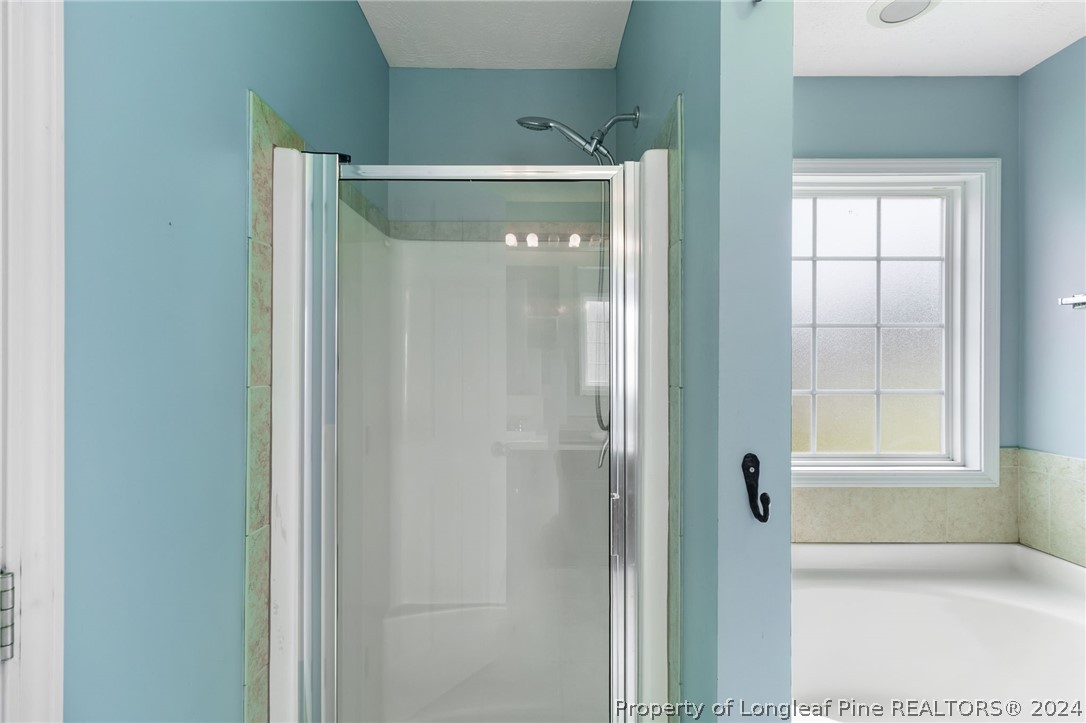 519 Cape Fear Road Raeford, NC 28376 - Photo 17 of 39 a bathroom with a glass shower door