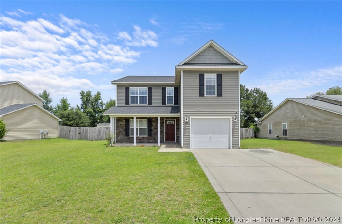 519 Cape Fear Road Raeford, NC 28376 - Photo 2 of 39 a front view of a house with a yard and garage