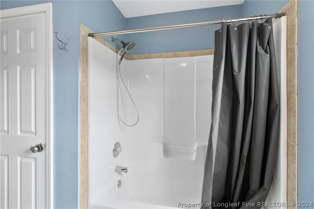 519 Cape Fear Road Raeford, NC 28376 - Photo 29 of 39 a bathroom with a shower and a glass door
