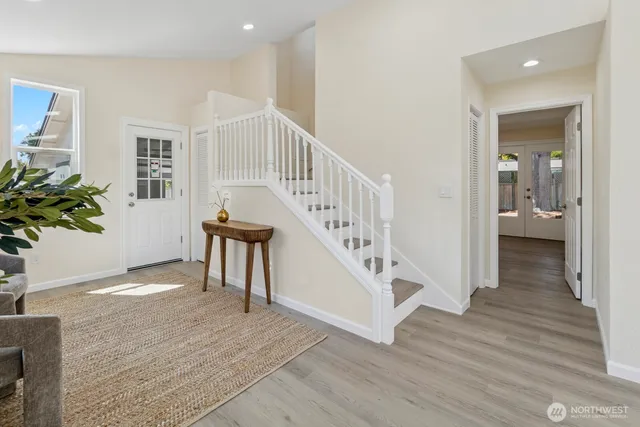 a view of entryway with wooden floor and stairs